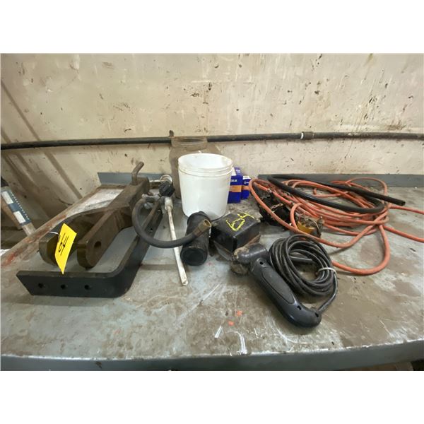 Lot of extension cords, starter switches, hitch receivers. On counter.
