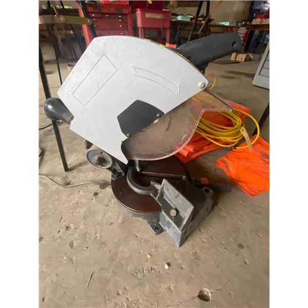 Large orange tarp, extension cord, and cut off saw which works.