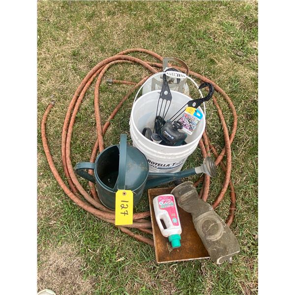 Assorted garden tools. Hose, water can, tomato fertilizer, sprinkler and propane tank etc.