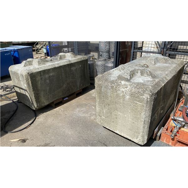 PAIR OF LARGE CEMENT FOUNDATION BLOCKS APPROX 5000LB EACH ON METAL STANDS WITH FORKLIFT SLOTS