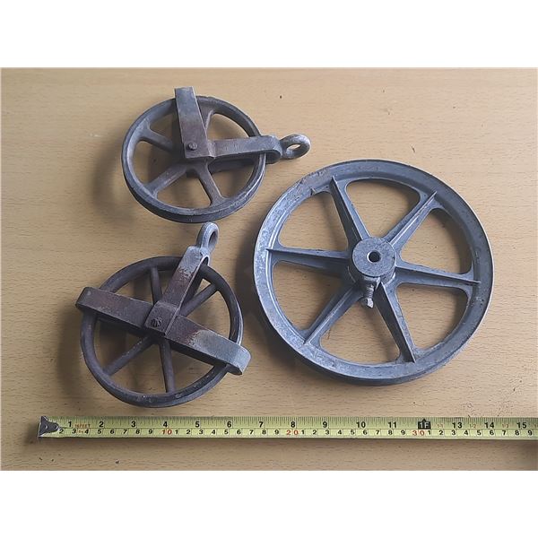 Antique industrial cast iron pulley wheels.