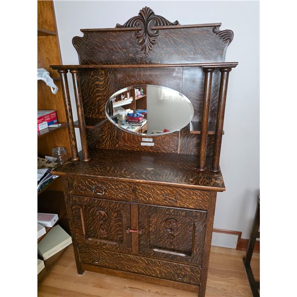 Wooden display cabinet with bevelled mirror back. Drawers and doors for storage area open.- 40.5" by