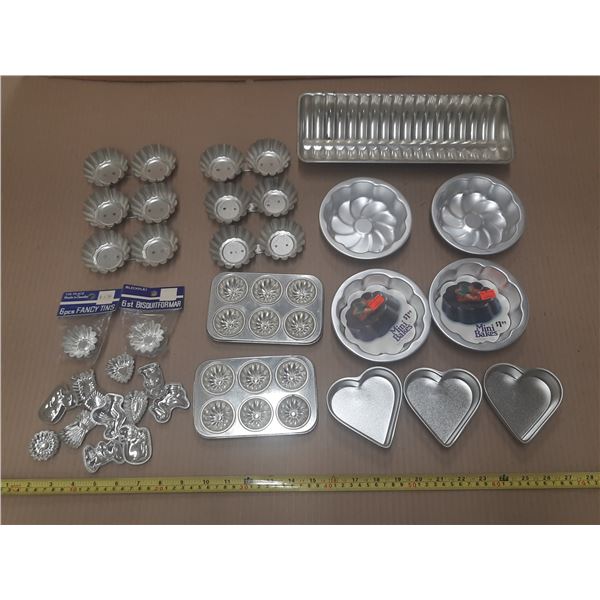 Set of various aluminum baking molds and tins.