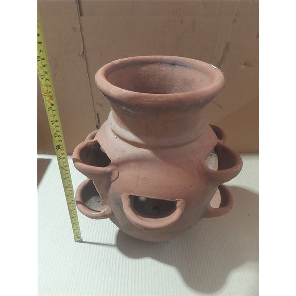 Terracotta strawberry pot with multiple side openings.