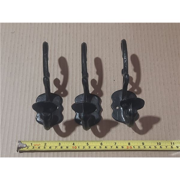(3) Black cast iron wall hooks.