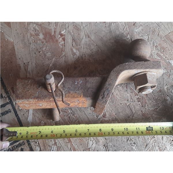 Rusty trailer hitch receiver mount with a ball attached.
