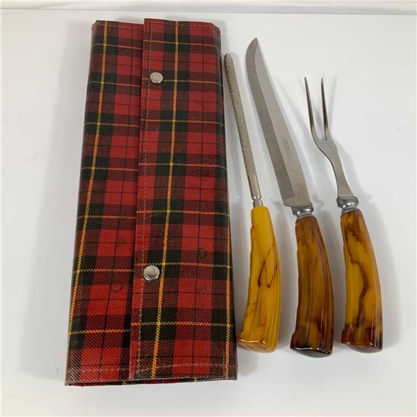 A Vintage Three-Piece Stainless Steel Carving Set with Faux-Horn Handles and Plaid Case