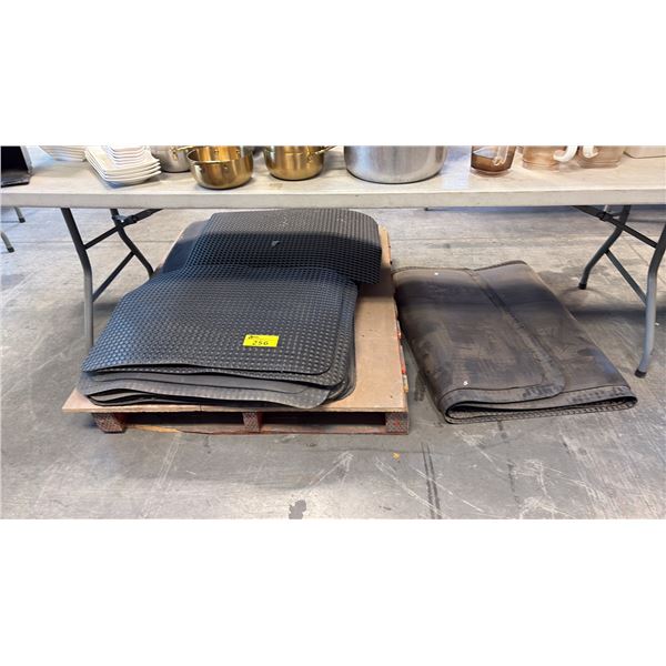STACK OF HEAVY-DUTY BLACK PLASTIC/RUBBER ANTI-FATIGUE MATS AND RUNNERS