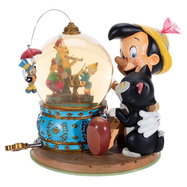 A  "Pinocchio " Snow Globe with Accessories.