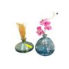 Image 1 : 2 Hand-Blown Iridescent Blue-Green Glass Vases with Faux Orchid and Floral Accents
