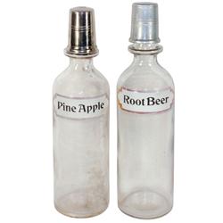 Syrup bottles (2), Root Beer & Pine Apple w/paper labels & metal pour caps (Root Beer has some rough