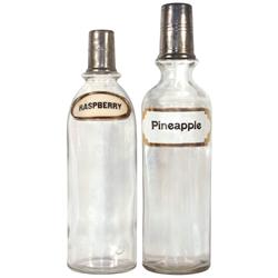 Syrup bottles (2), Raspberry & Pineapple, Raspberry has label under glass, Pineapple has paper label