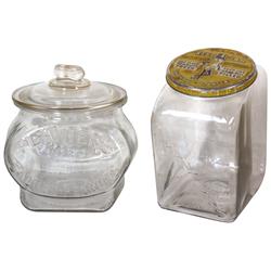 Planters Peanut jars (2), embossed slant shape w/tin lid & embossed 'football' w/glass lid & peanut 