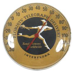 Florists' Telegraph Delivery Interflora thermometer, glass dome in metal frame, few dents in metal f