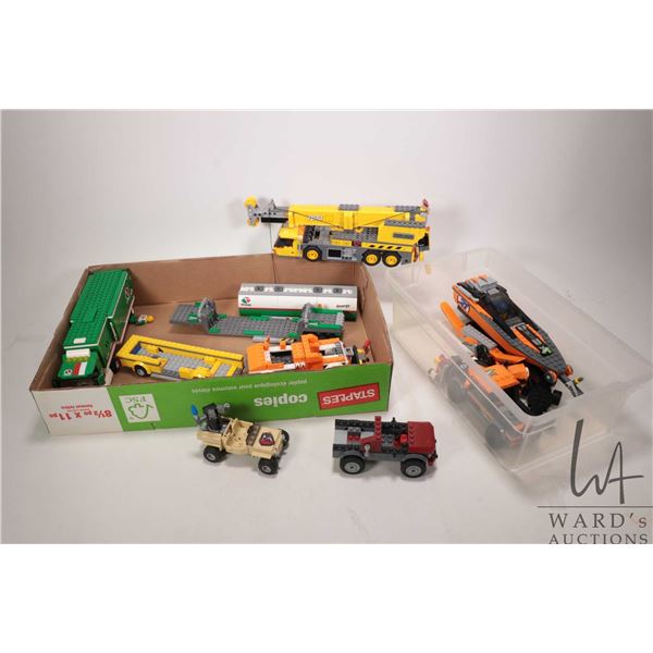 Selection of Lego City and Technics pre-built vehicle kits including boats and tanker trucks, crane 