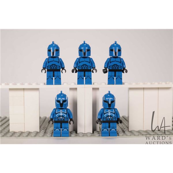 Five Lego Star Wars minifigures including three Senate Commando Troopers and two Senate Commando Cap