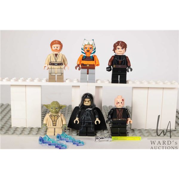 Six Lego Star Wars minifigures including Obi-Wan Kenobi, Anakin Skywalker, Ahsoka tano (missing hand