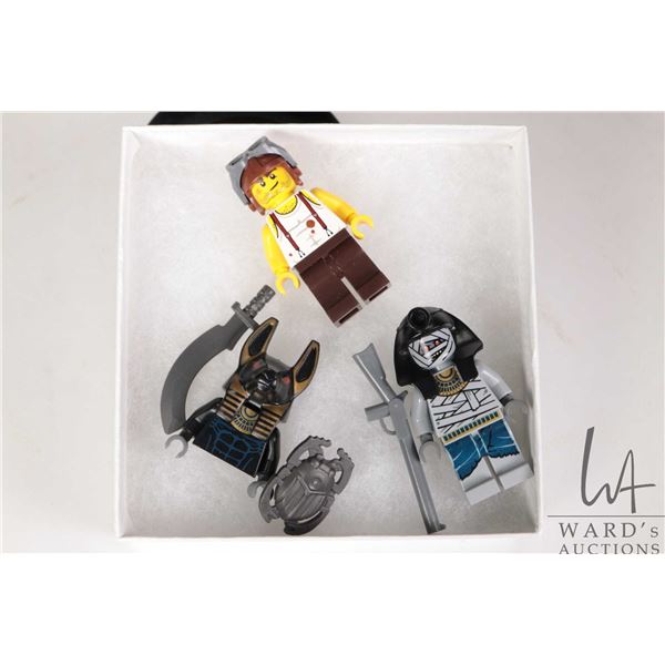 Three Lego minifigures including Mummy Warrior 1, Mac McCloud, Partial Anubis Guard.