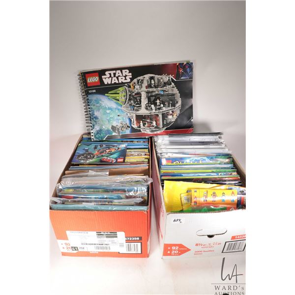 Two boxes of Lego kit building guides
