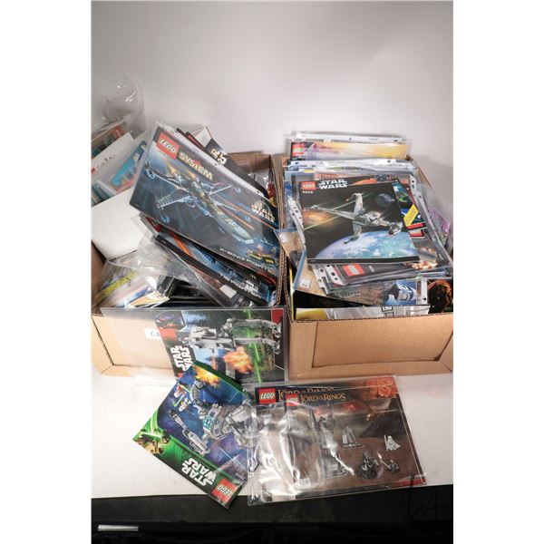 Two boxes of Lego kit building guides
