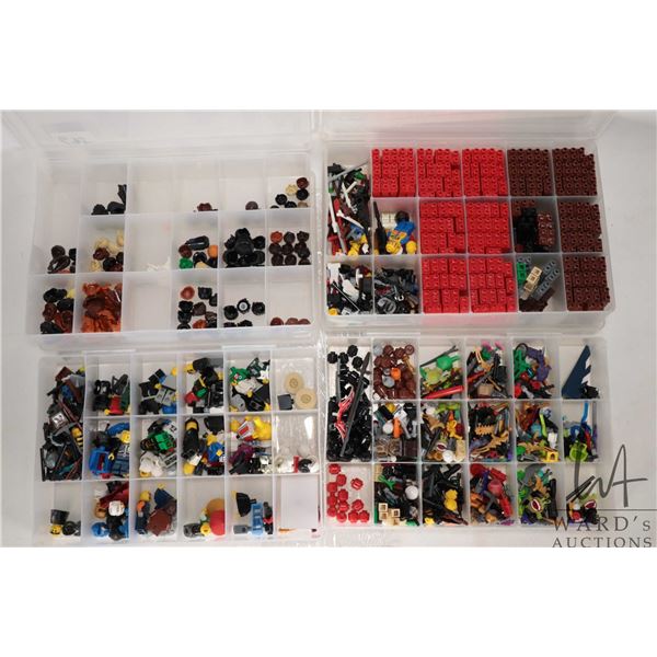 Four plastic containers filled with body parts and accessories for Minifigures
