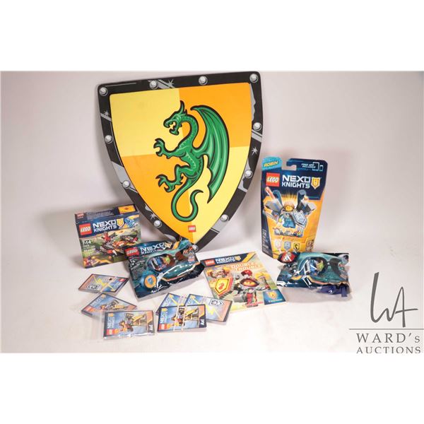 Selection of Lego- Nexus Knights collectibles including shield, trading cards, small chapter books, 