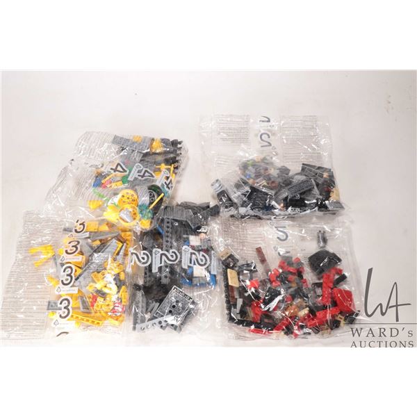 Five factory sealed packages of Lego building bricks, unknown origins