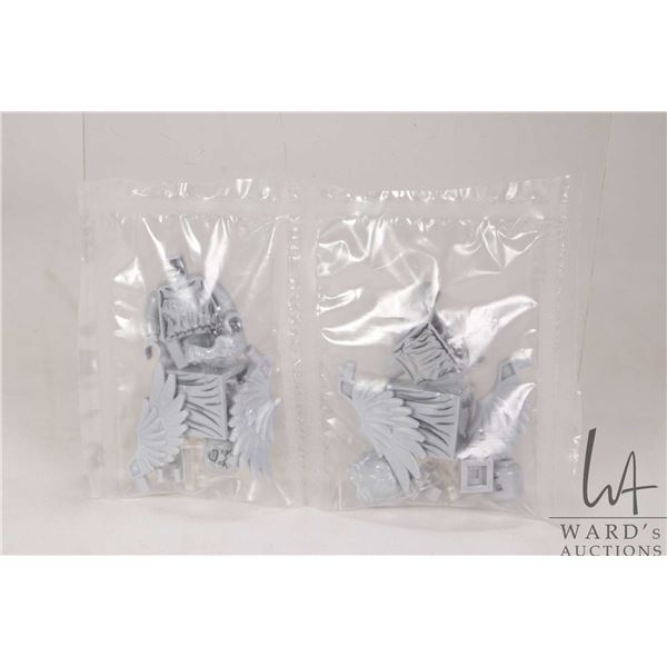Two Lego Doctor Who Weeping Angels minifigures, taken apart, stored in plastic.