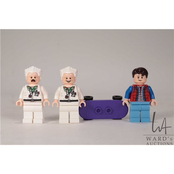Three Lego Back to The Future minifigures 2 Doc browns, Marty Mcfly with skateboard.