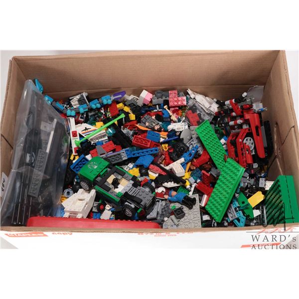 Box containing a large selection of Lego building bricks and accessories, various themes