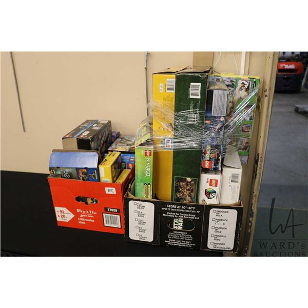 Two boxes containing a large selection of empty Lego building kit boxes, various themes