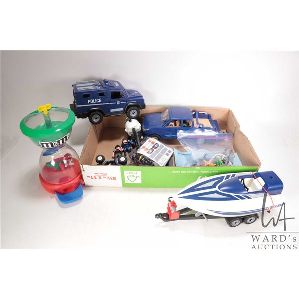 Selection of Playmobile police vehicles and figures plus an M&M's candy dispenser