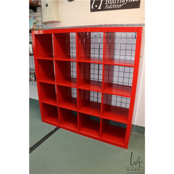 Red sixteen cubby display unit 59"H X 59" W X 15" D