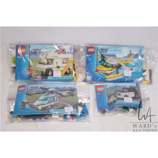 Four Lego "City" sets including Small Car (3177), Police Helicopter (7741), Seaplane (3178), and Cam