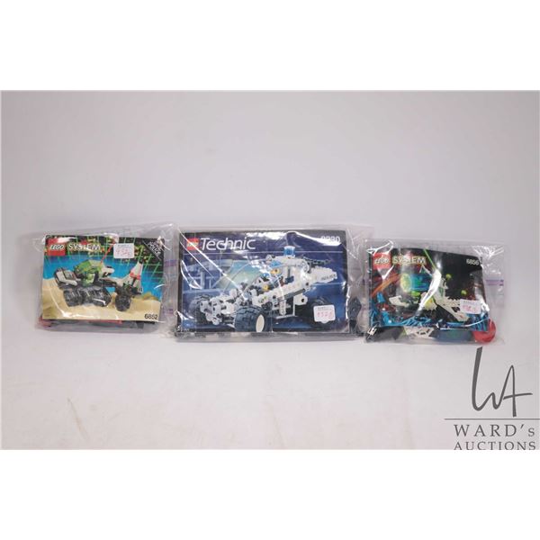 Three Lego sets including Sonar Security (6852) with manual, Planetary Decoder with manual (6856), a