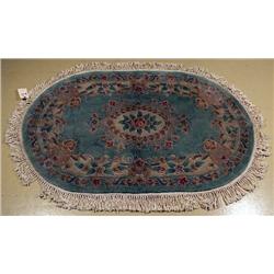 A Chinese Oval Wool Rug with Back Cover,