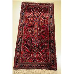 An Antique Persian Sarouk Wool Rug.