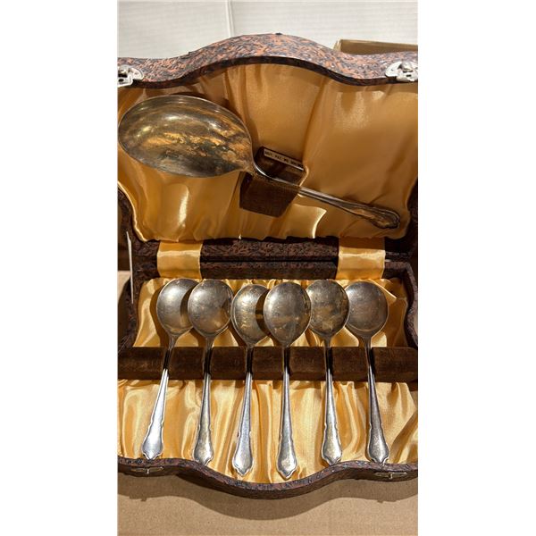 Silver plate, dessert, and serving spoons in case