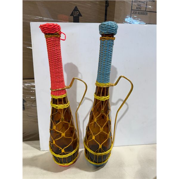 vintage 1970s amber glass bottle featuring a blue and pink  plastic "scoubidou" woven covering and a