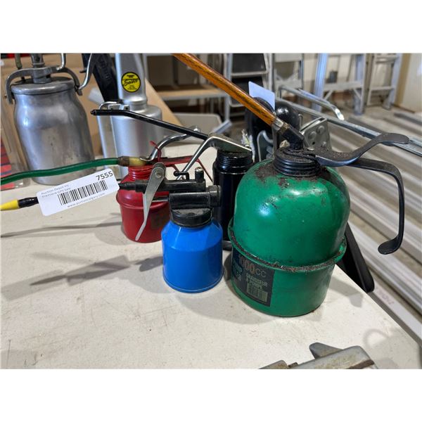 Four Metal Oil Cans in Various Colors and Sizes