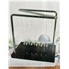 Image 1 : Newton's Cradle Desktop Accessory With Metal Frame and Wooden Base