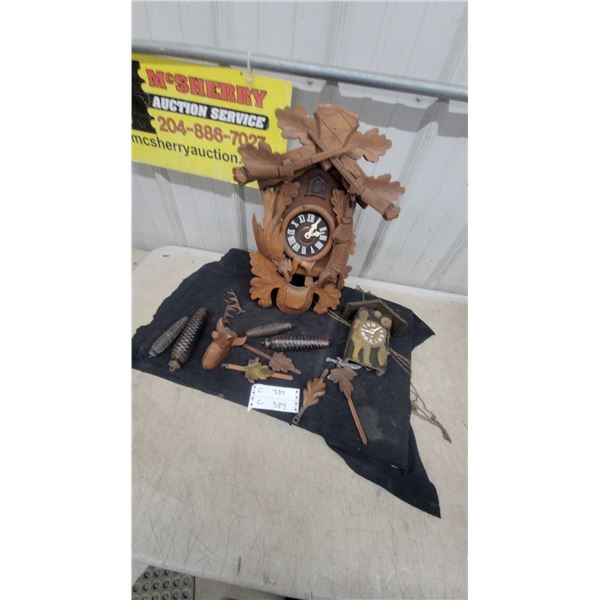 Two German-Style Carved Wood Cuckoo Clocks with Pinecone Weights and Accessories