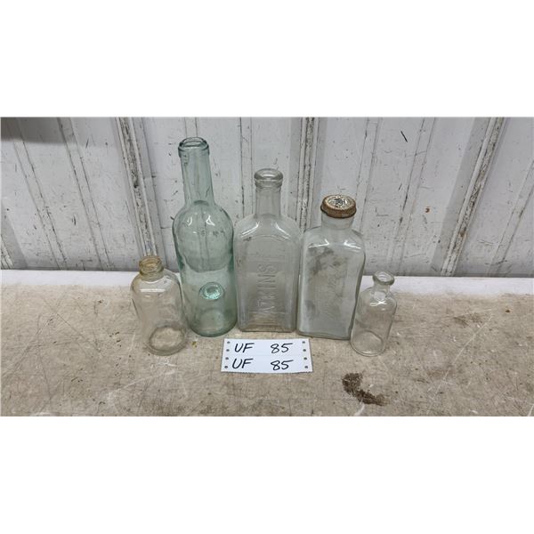 Collection of Five Vintage Glass Bottles Including Watkins and Rawleigh