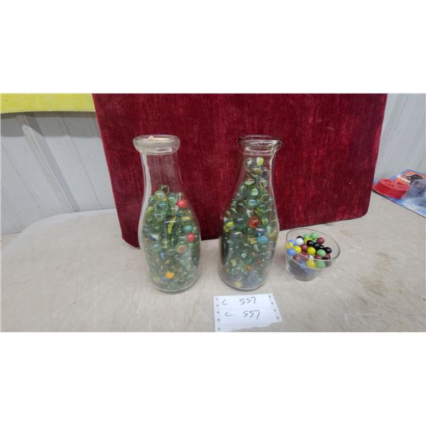 Vintage Glass Milk Bottles Filled with Marbles and Small Bowl of Solid Color Marbles