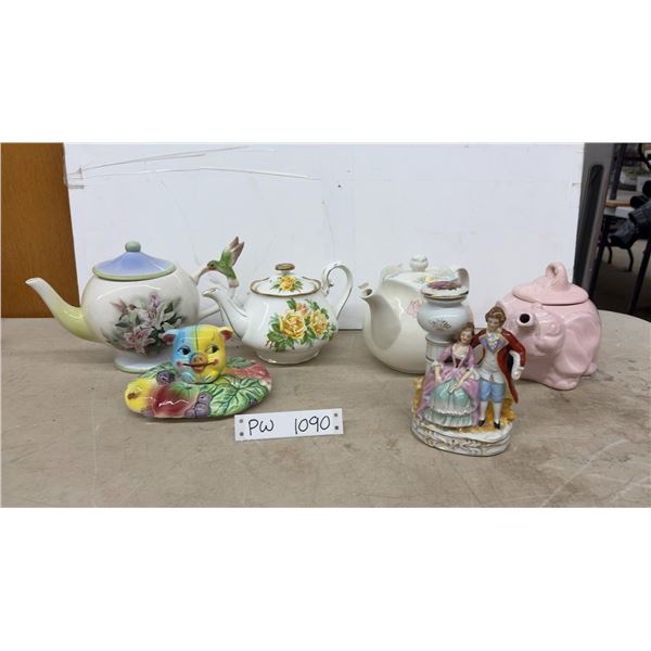 4 Teapots, Cookie Jar Lid, and 1 China Man &Women