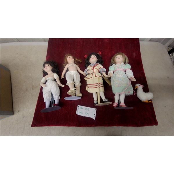 Four Porcelain Collector Dolls with Period-Style Clothing, Stands, and Stuffed Duck