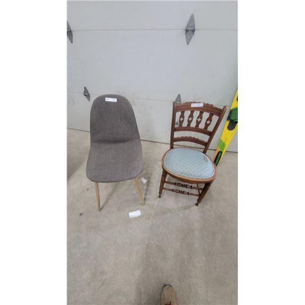 Modern Gray Upholstered Dining Chair and Antique Carved Wooden Chair with Quatrefoil Motifs