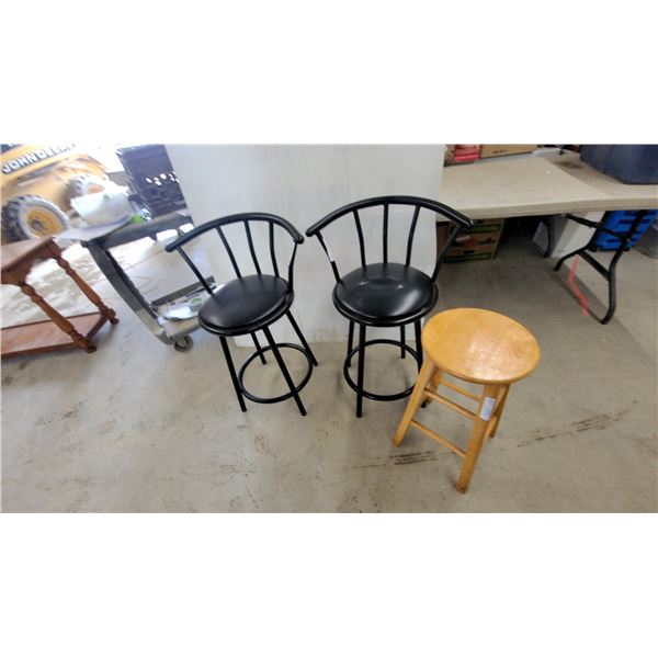 Two Black Metal Swivel Bar Stools with Curved Backs and Round Wood Stool