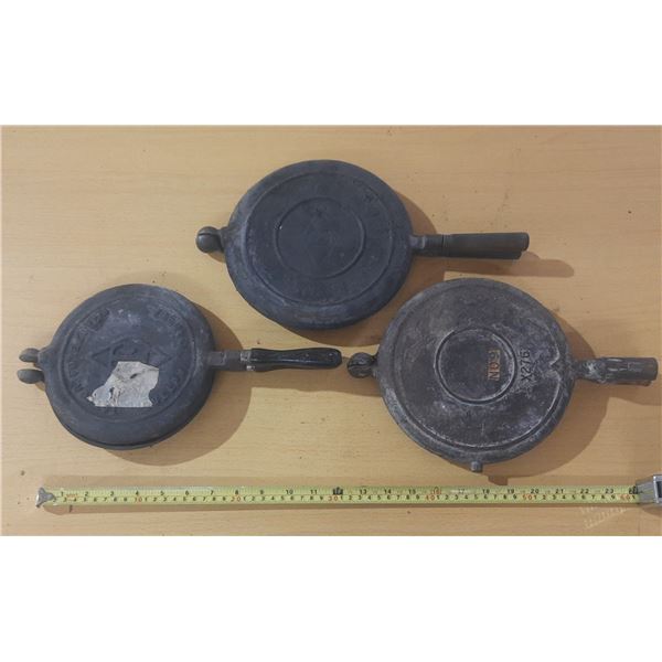 Vintage cast iron waffle irons.