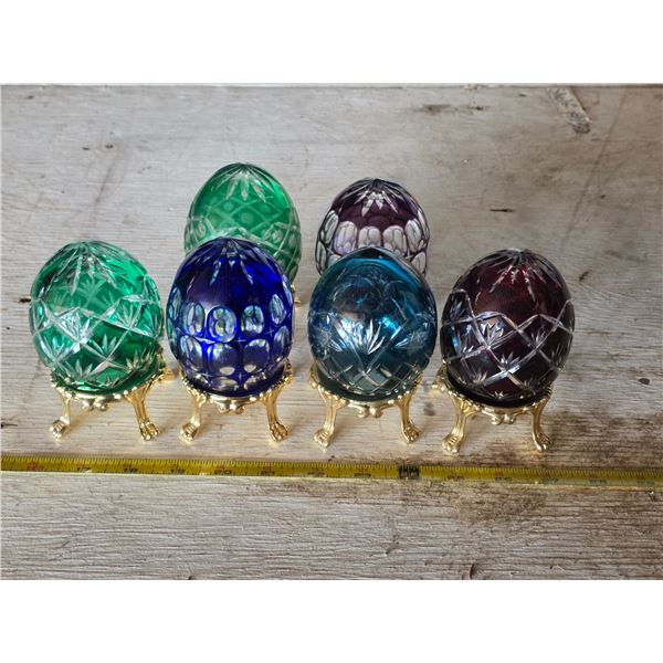 6 glass eggs and gold colored stand